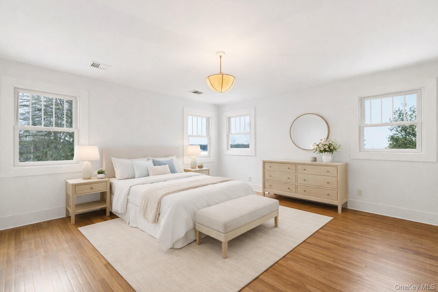 7 Landing Road Huntington, NY 11743 - Photo 15 of 42 a bedroom with a bed mirror on dresser and a window