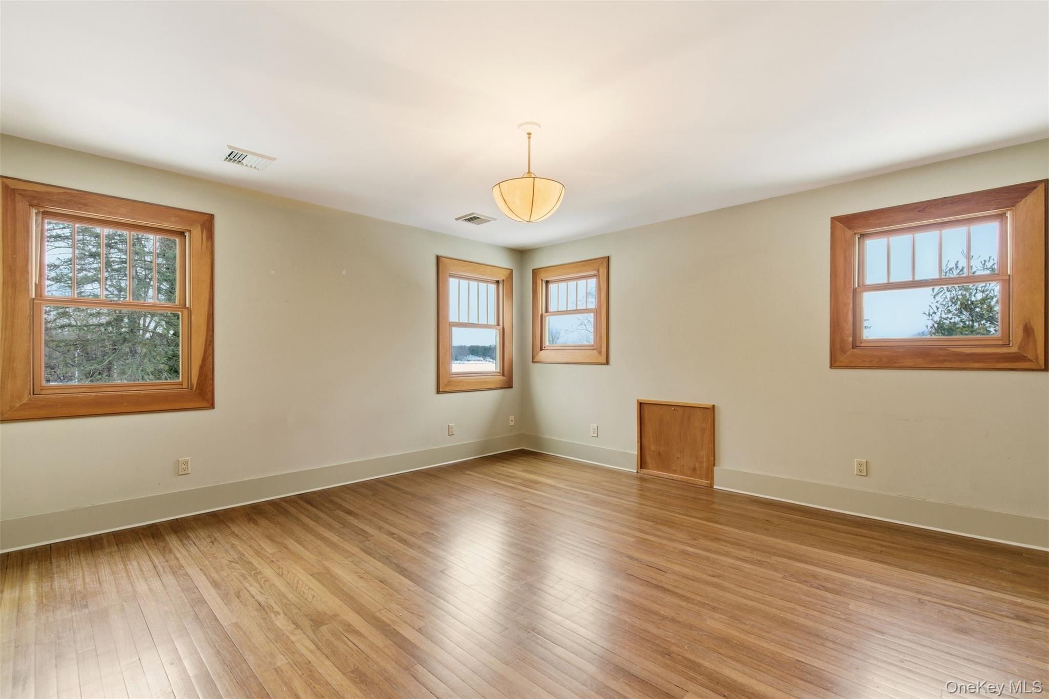 7 Landing Road Huntington, NY 11743 - Photo 16 of 42 a view of an empty room with wooden floor and a window