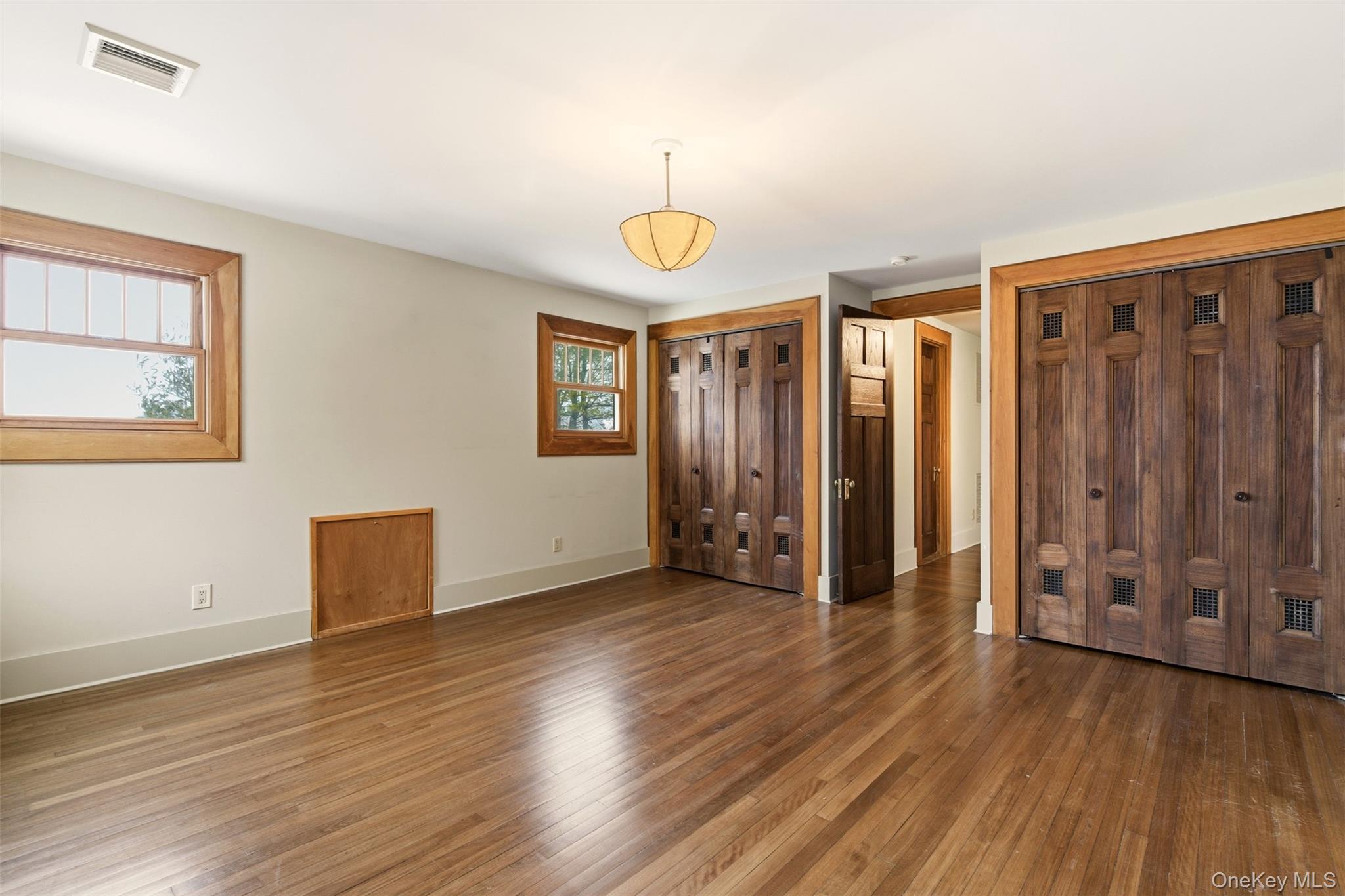 7 Landing Road Huntington, NY 11743 - Photo 17 of 42 a view of an empty room with wooden floor and window