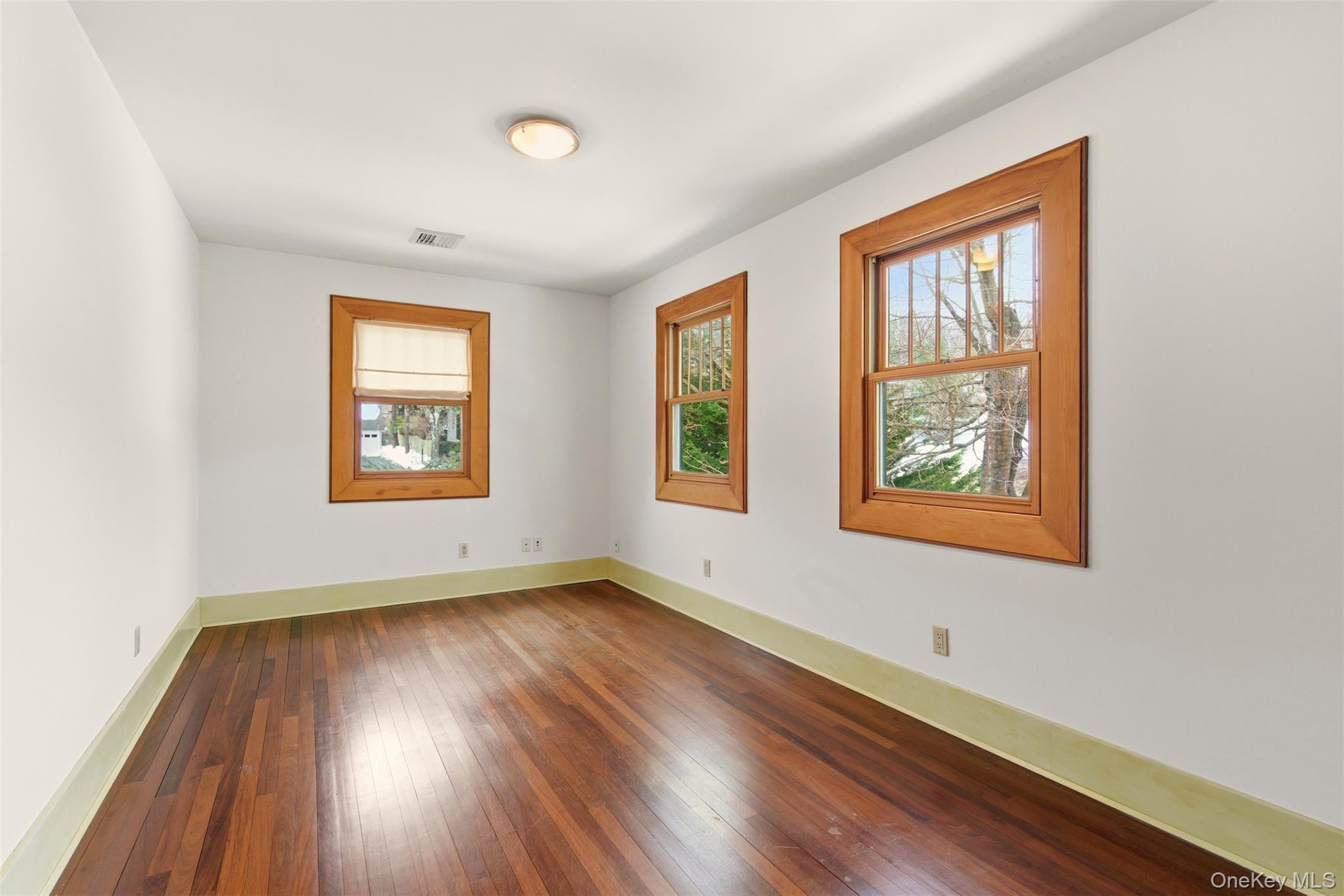 7 Landing Road Huntington, NY 11743 - Photo 20 of 42 an empty room with wooden floor and windows