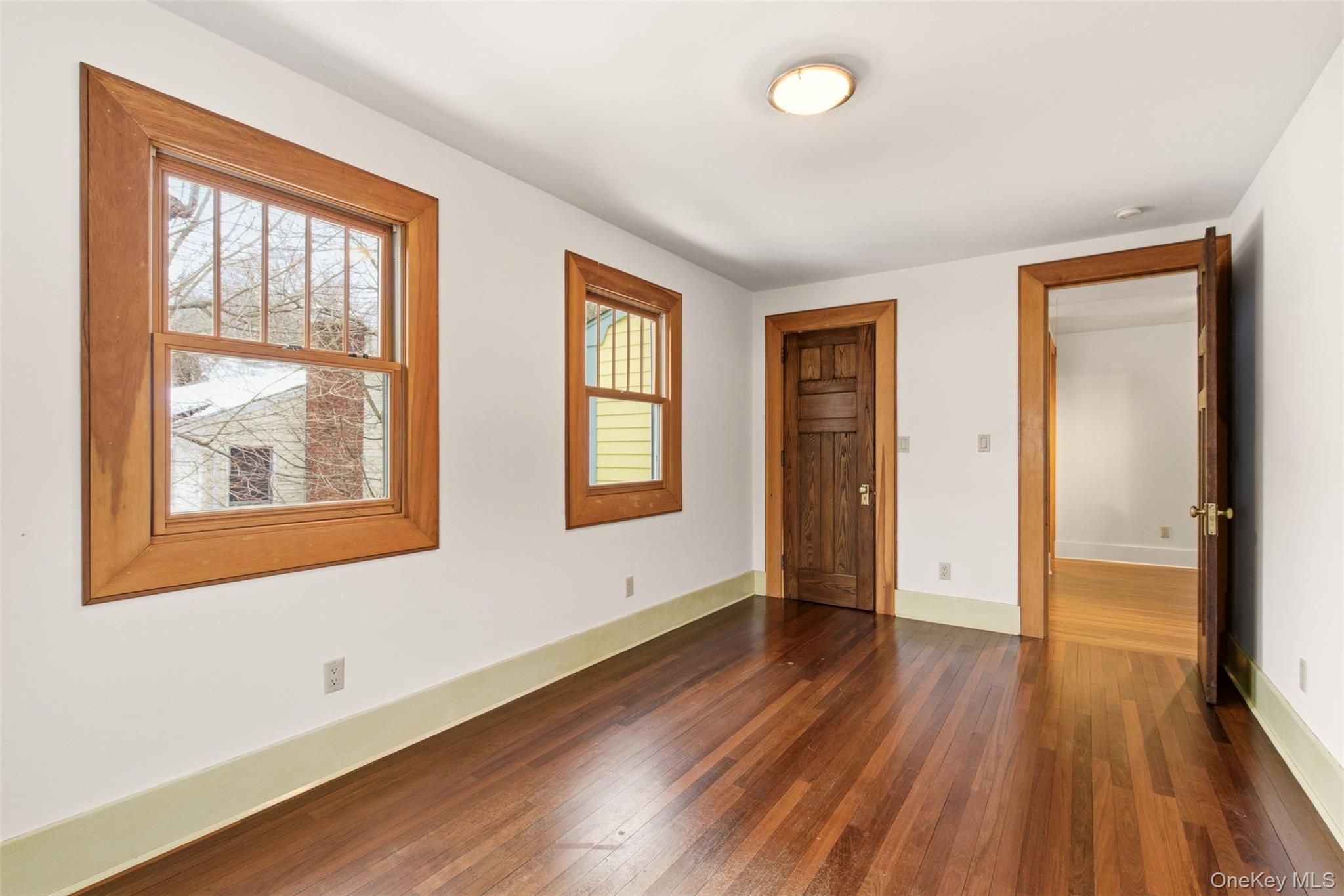 7 Landing Road Huntington, NY 11743 - Photo 21 of 42 an empty room with wooden floor and windows