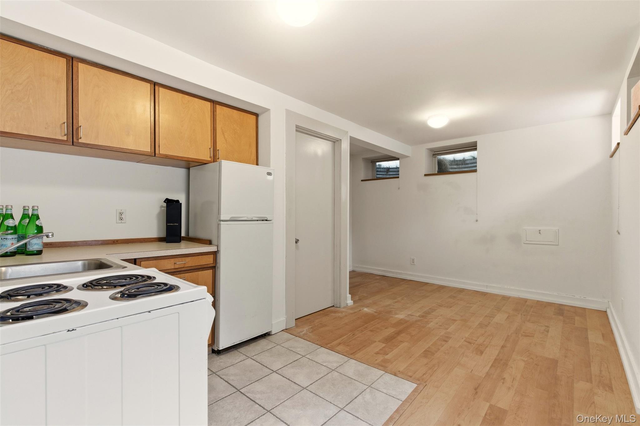 7 Landing Road Huntington, NY 11743 - Photo 29 of 42 a kitchen with a stove a refrigerator and a white cabinets