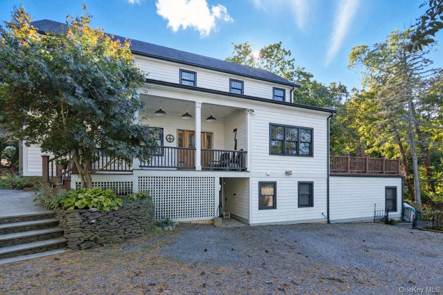 7 Landing Road Huntington, NY 11743 - Photo 4 of 42 a view of a white house with large windows and a small yard