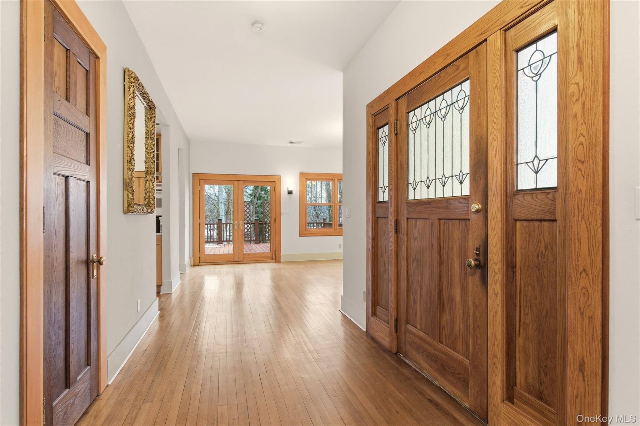7 Landing Road Huntington, NY 11743 - Photo 7 of 42 a view of a entryway with wooden floor and windows