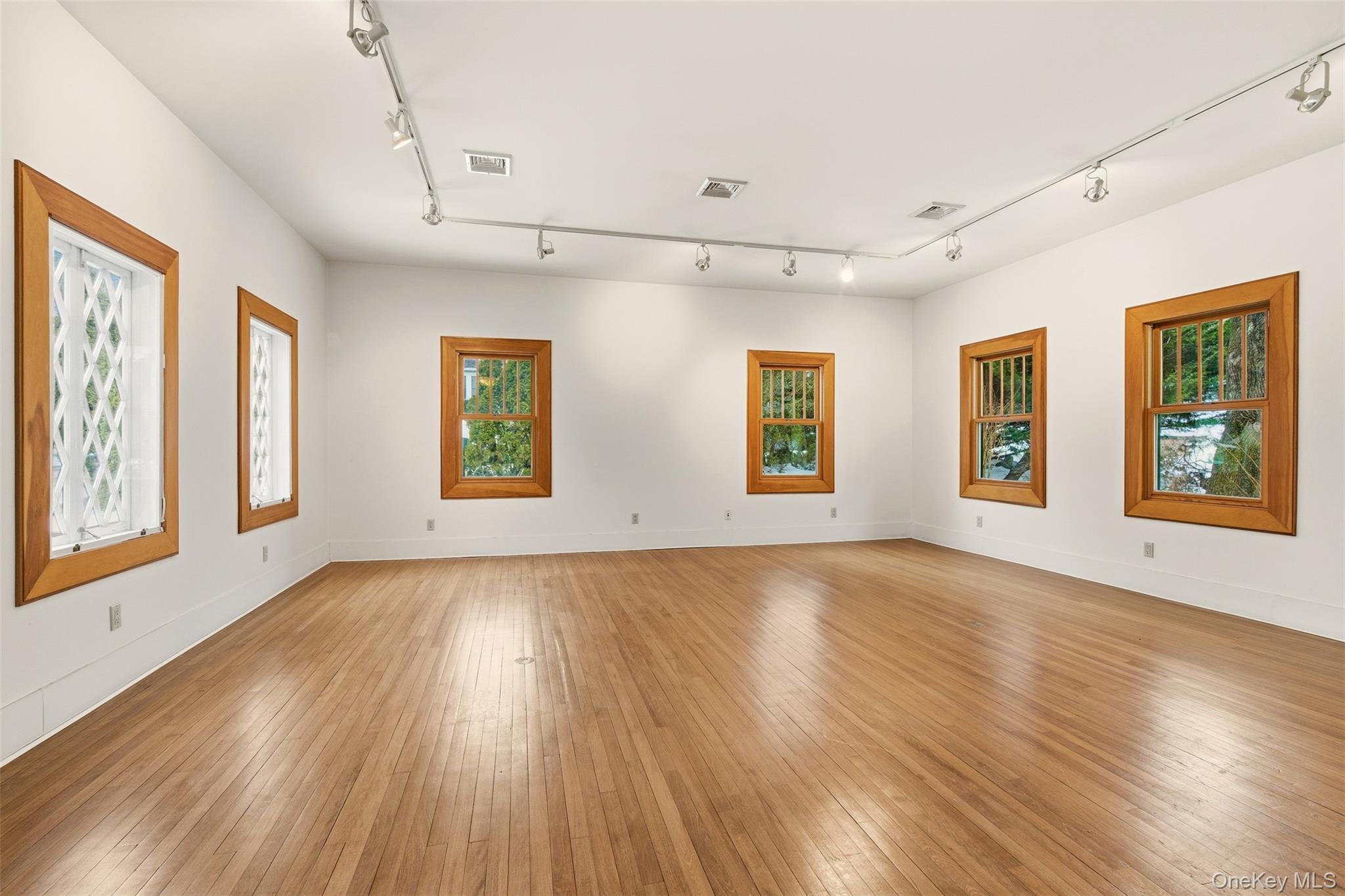 7 Landing Road Huntington, NY 11743 - Photo 9 of 42 a view of an empty room with wooden floor and a window