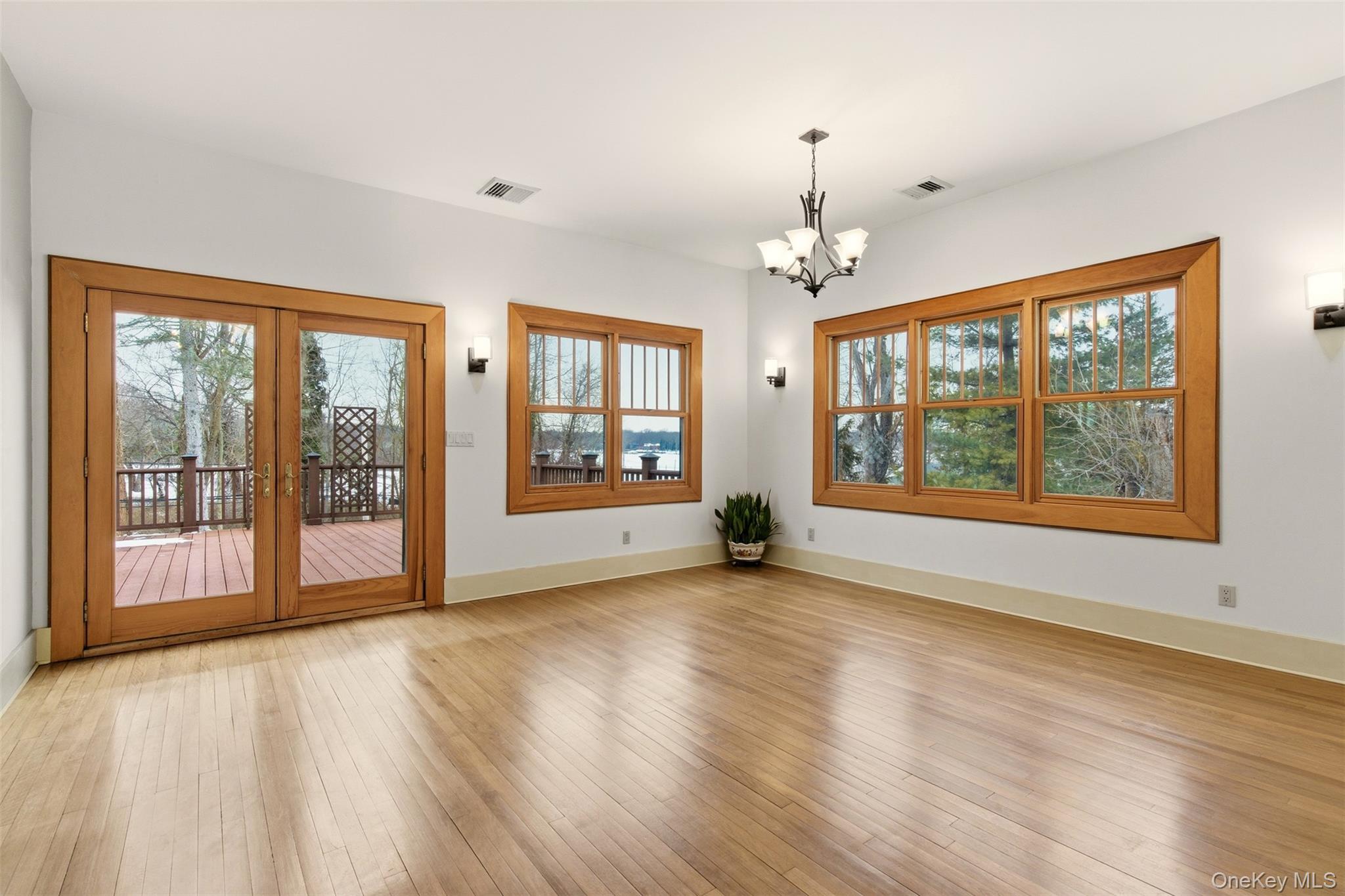 7 Landing Road Huntington, NY 11743 - Photo 10 of 42 a view of an empty room with a window and wooden floor
