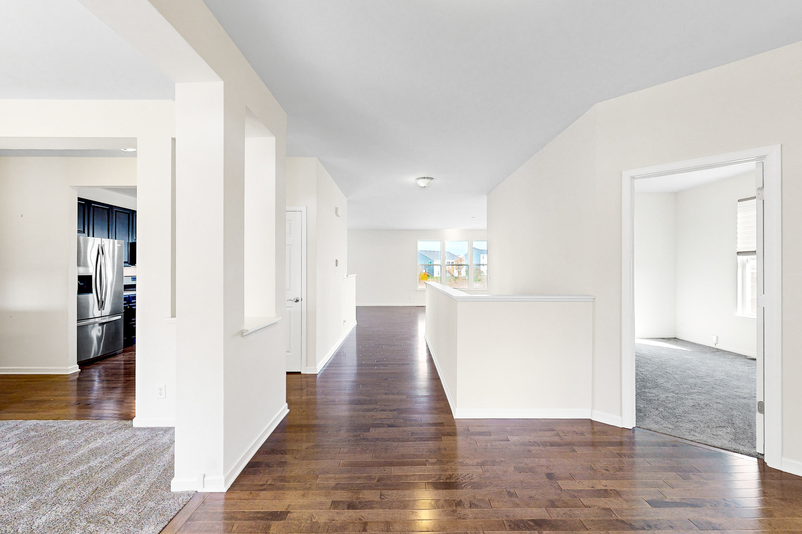 731 Windett Ridge Road Yorkville, IL 60560 - Photo 14 of 28 a view of a kitchen and an empty room with wooden floor