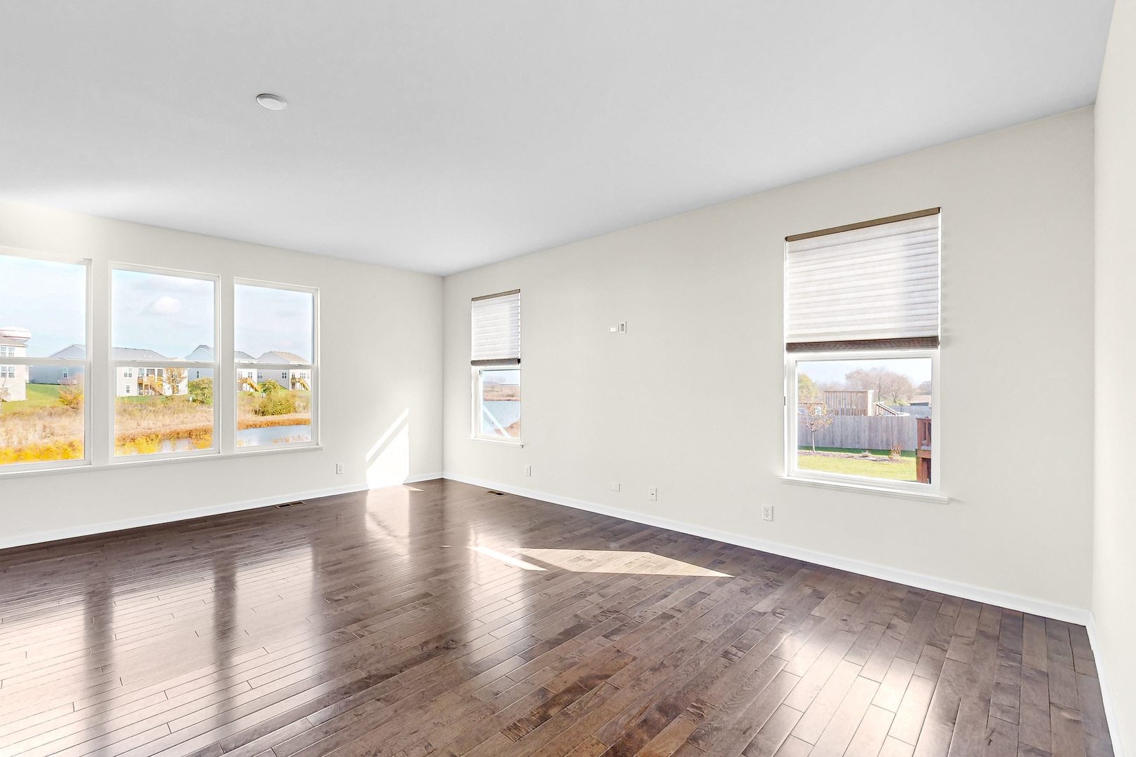 731 Windett Ridge Road Yorkville, IL 60560 - Photo 15 of 28 an empty room with wooden floor and windows