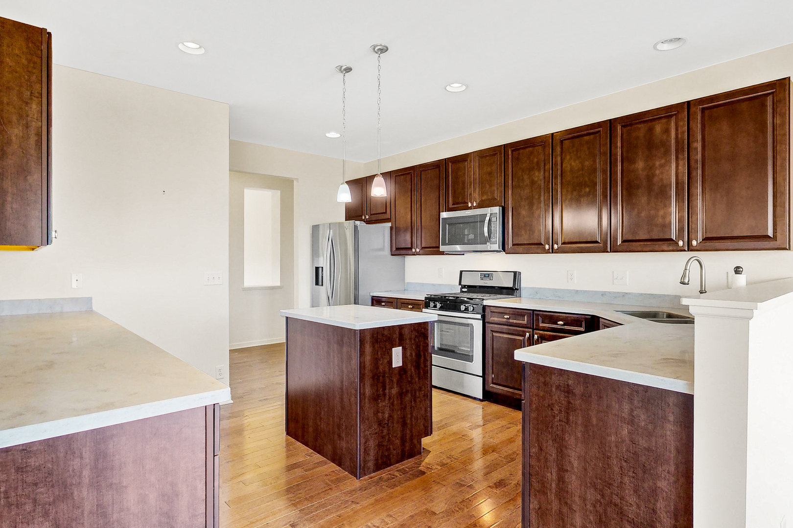 731 Windett Ridge Road Yorkville, IL 60560 - Photo 4 of 28 a kitchen with stainless steel appliances granite countertop wooden cabinets a stove top oven a sink and dishwasher