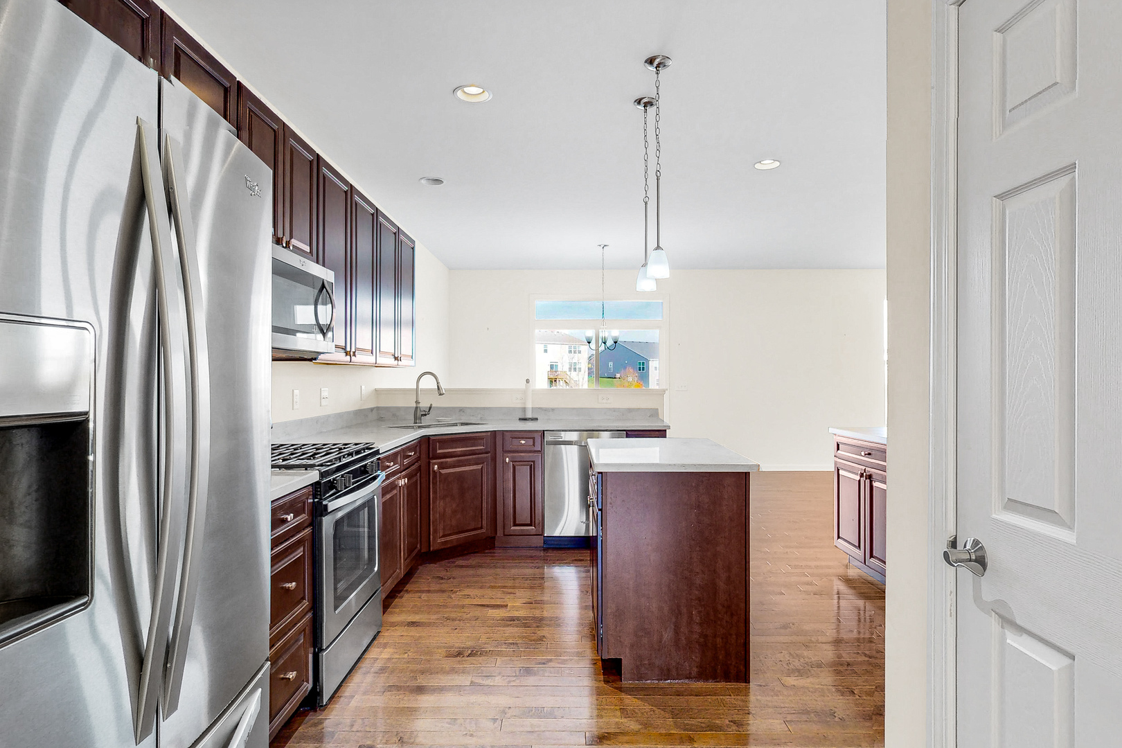 731 Windett Ridge Road Yorkville, IL 60560 - Photo 5 of 28 a kitchen with stainless steel appliances granite countertop a refrigerator a stove and a sink