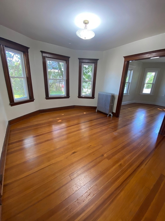 14 Welton Road Boston, MA 02132 - Photo 14 of 31 a view of an empty room with window and wooden floor