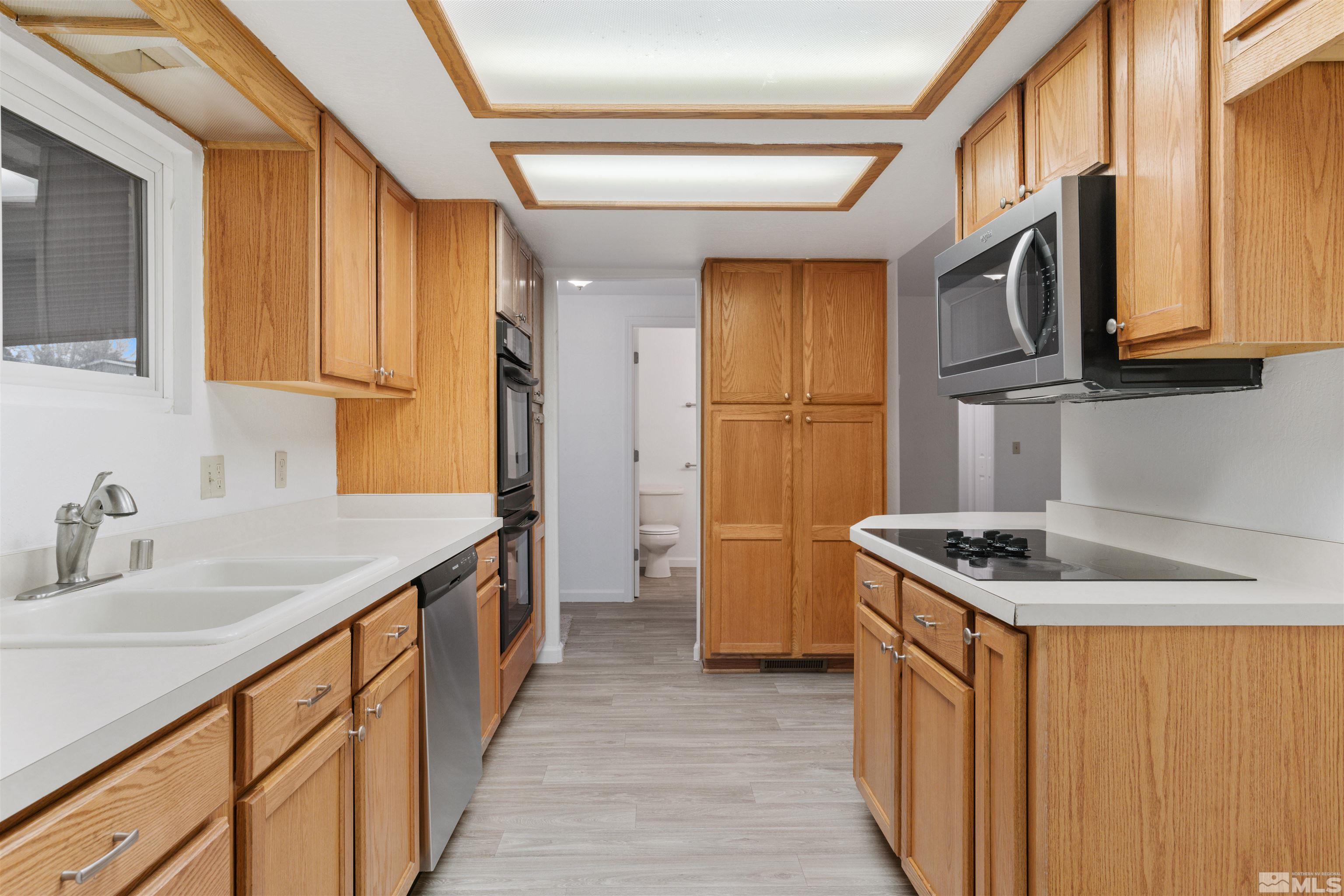 210 Zircon Drive Reno, NV 89521 - Photo 1 of 35 a kitchen with stainless steel appliances granite countertop a sink and a stove