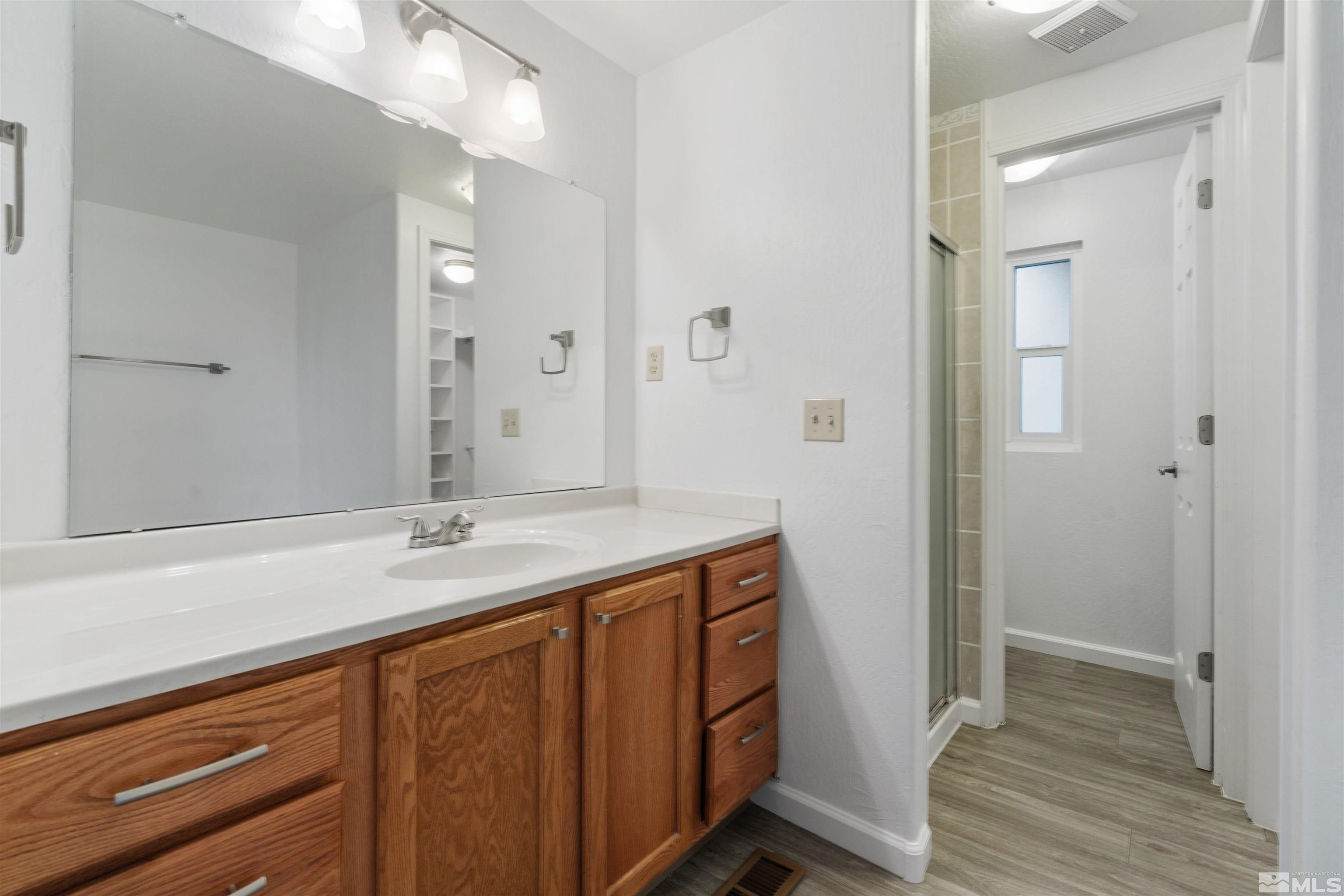210 Zircon Drive Reno, NV 89521 - Photo 11 of 35 a bathroom with a sink and a mirror