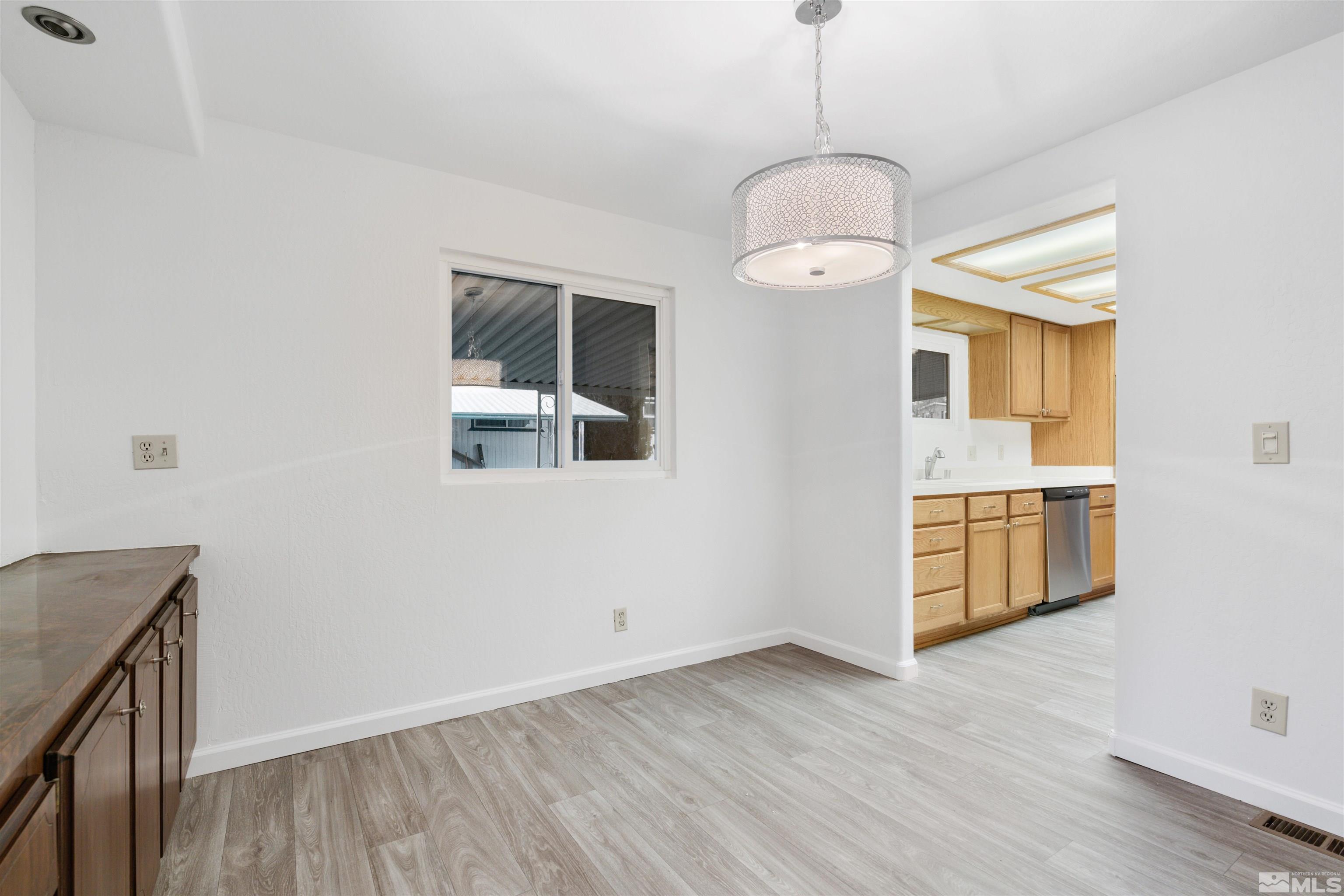 210 Zircon Drive Reno, NV 89521 - Photo 2 of 35 a view of an empty room with window and wooden floor