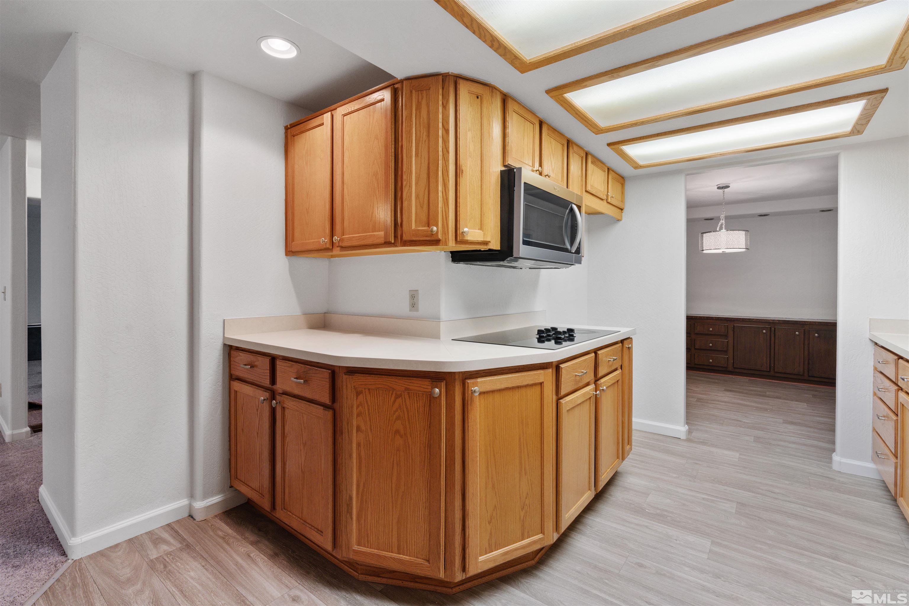210 Zircon Drive Reno, NV 89521 - Photo 7 of 35 a kitchen with stainless steel appliances granite countertop a sink and a microwave