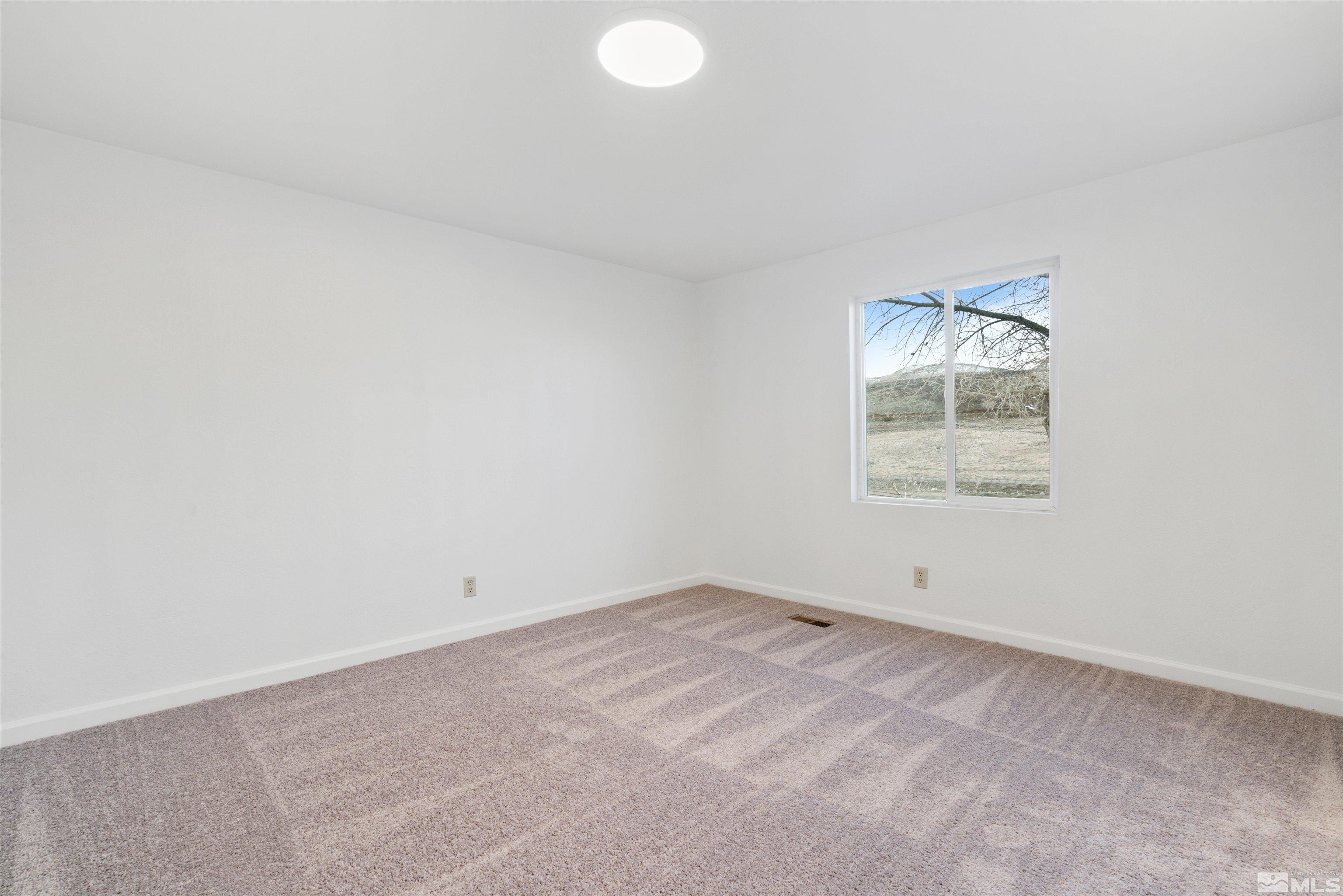 210 Zircon Drive Reno, NV 89521 - Photo 8 of 35 an empty room with a empty space and window