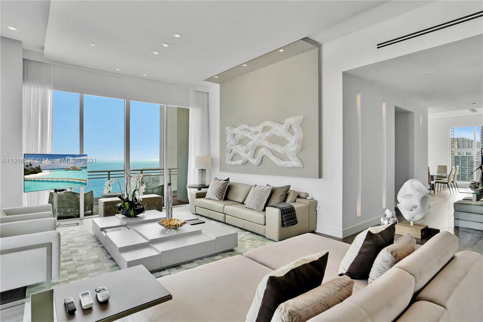 900 Brickell Key Boulevard, Unit PH4 Miami, FL 33131 - Photo 11 of 79 a living room with furniture and a painting on the wall