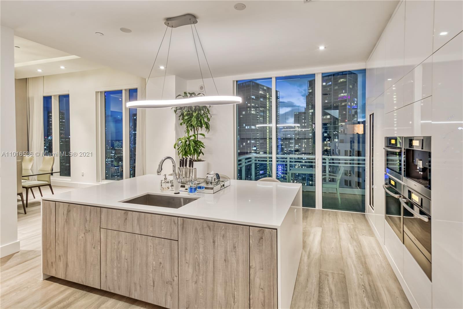 900 Brickell Key Boulevard, Unit PH4 Miami, FL 33131 - Photo 22 of 79 a kitchen with sink refrigerator and large window