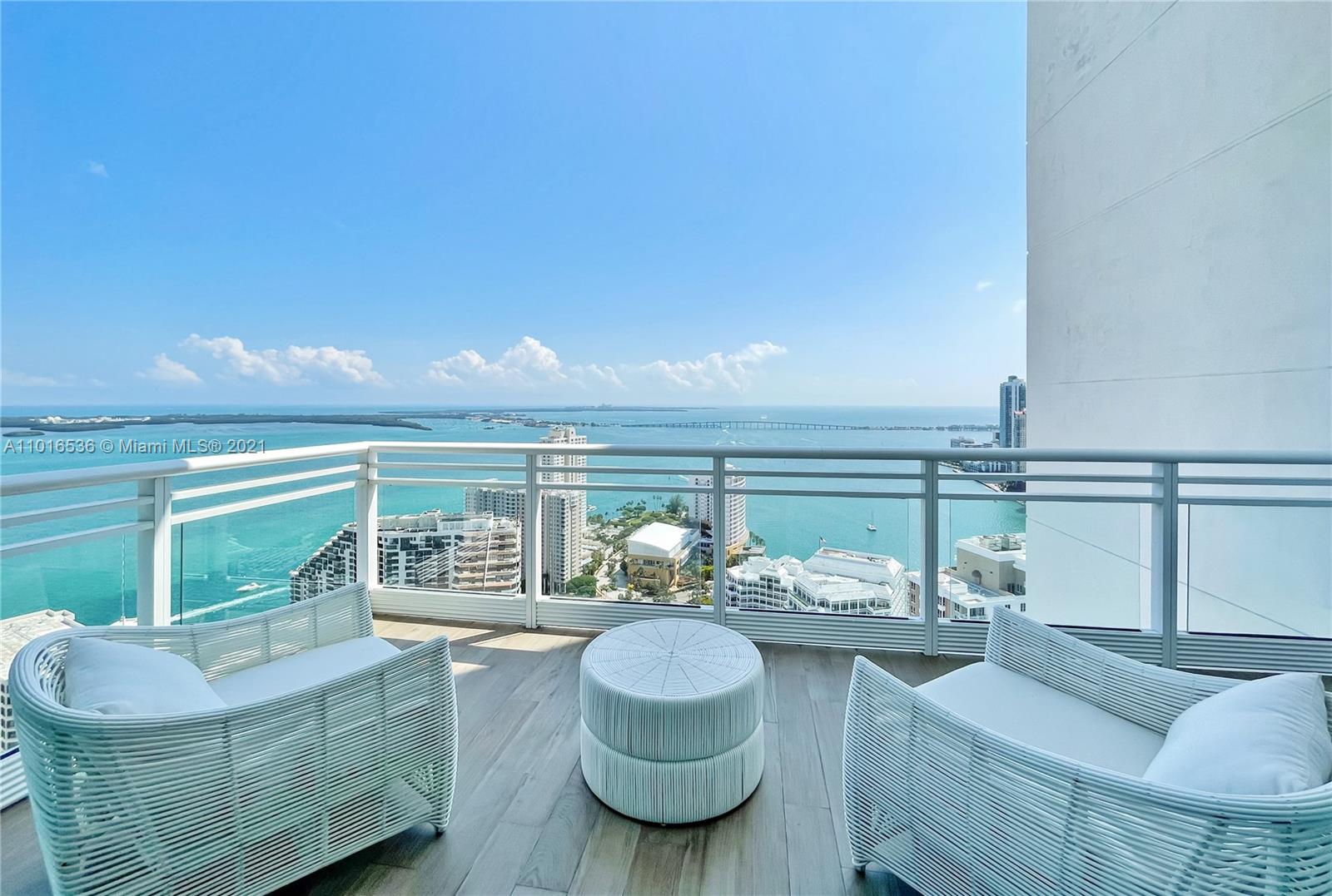 900 Brickell Key Boulevard, Unit PH4 Miami, FL 33131 - Photo 23 of 79 a living room with furniture and a floor to ceiling window