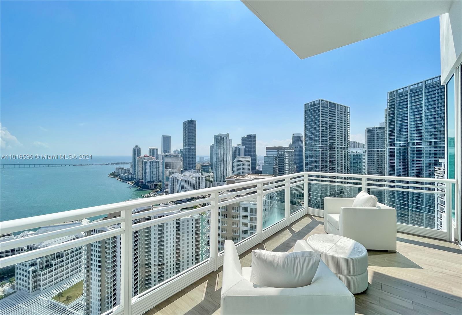 900 Brickell Key Boulevard, Unit PH4 Miami, FL 33131 - Photo 24 of 79 a view of a balcony with two chairs and a table