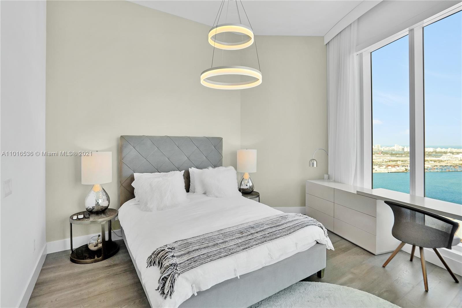 900 Brickell Key Boulevard, Unit PH4 Miami, FL 33131 - Photo 26 of 79 a bedroom with a bed and a window