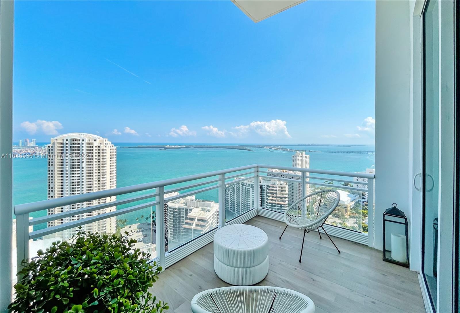 900 Brickell Key Boulevard, Unit PH4 Miami, FL 33131 - Photo 27 of 79 a view of a chairs and table in a balcony