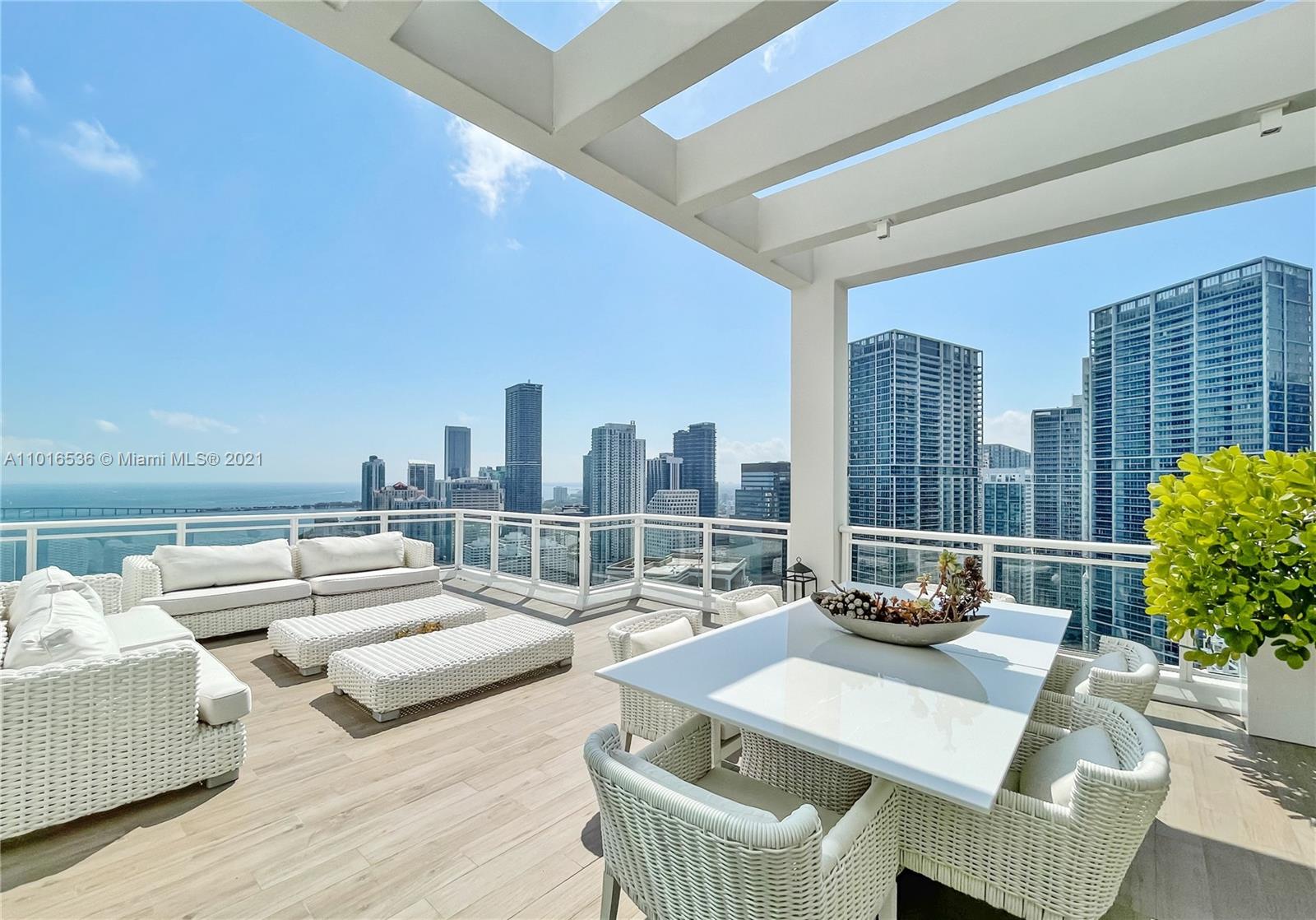 900 Brickell Key Boulevard, Unit PH4 Miami, FL 33131 - Photo 39 of 79 a living room with furniture and a floor to ceiling window
