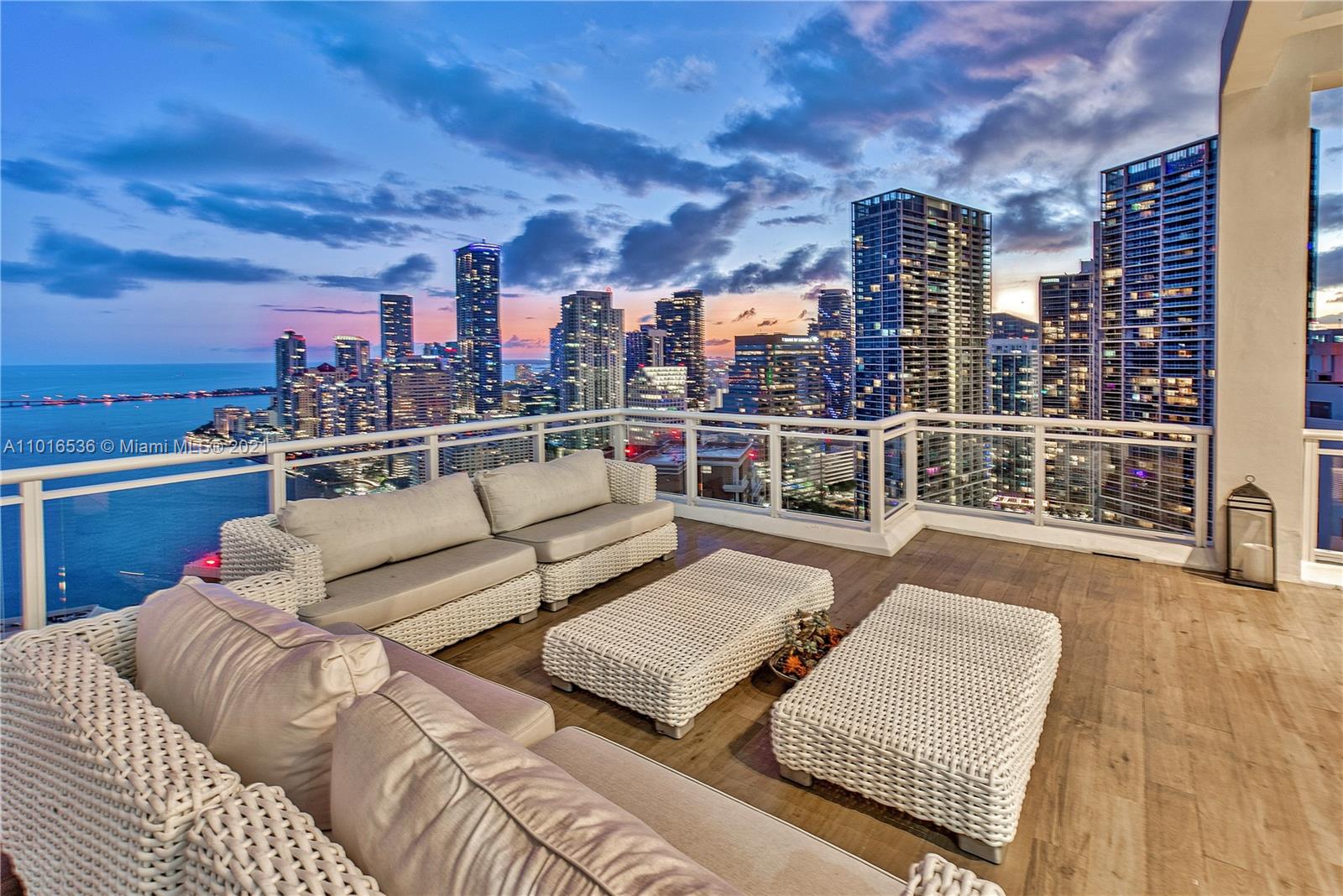 900 Brickell Key Boulevard, Unit PH4 Miami, FL 33131 - Photo 40 of 79 a view of a roof deck with couches and wooden floor