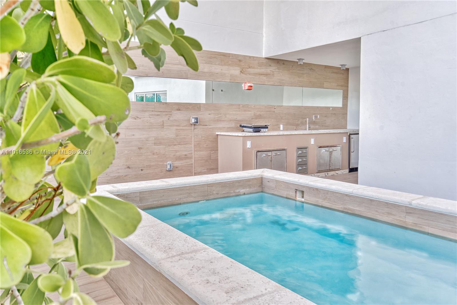 900 Brickell Key Boulevard, Unit PH4 Miami, FL 33131 - Photo 45 of 79 a view of a kitchen with a large window