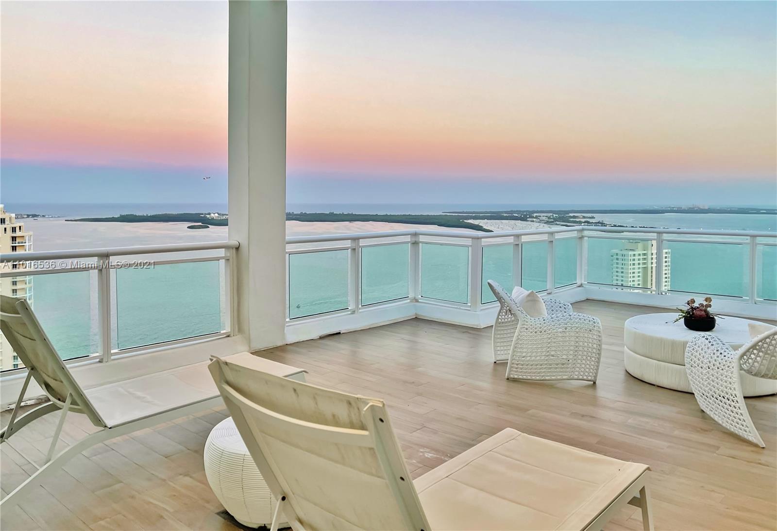 900 Brickell Key Boulevard, Unit PH4 Miami, FL 33131 - Photo 48 of 79 a living room with furniture and a floor to ceiling window