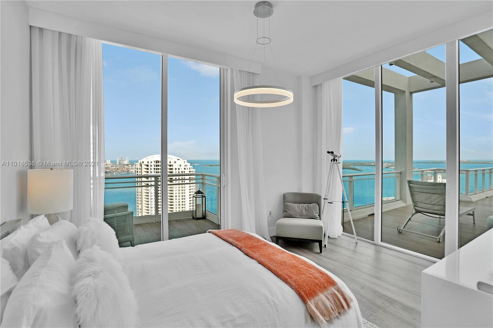 900 Brickell Key Boulevard, Unit PH4 Miami, FL 33131 - Photo 51 of 79 a bedroom with a bed and a chandelier