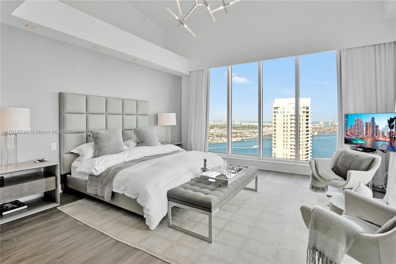 900 Brickell Key Boulevard, Unit PH4 Miami, FL 33131 - Photo 61 of 79 a bedroom with a bed and a couch