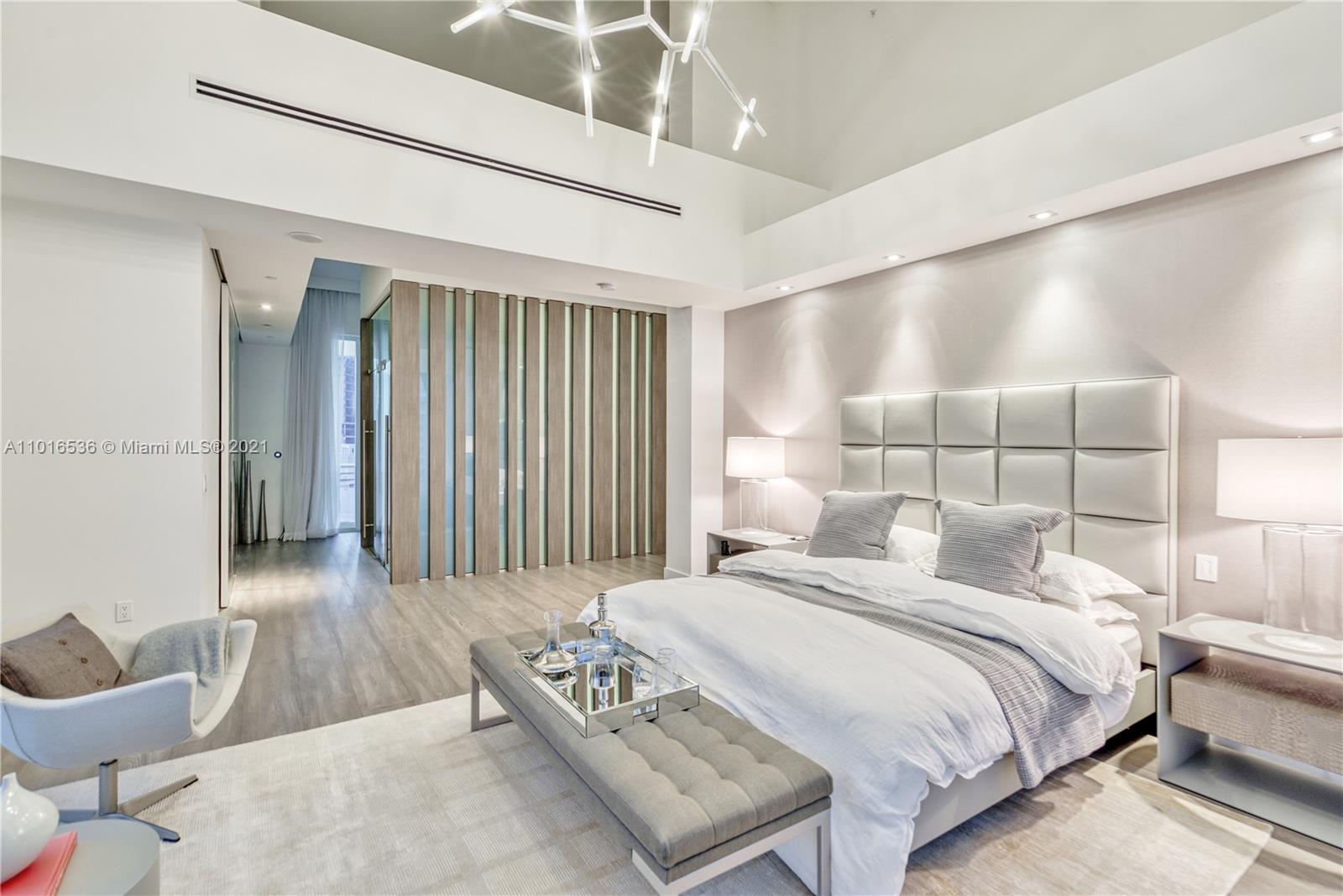 900 Brickell Key Boulevard, Unit PH4 Miami, FL 33131 - Photo 62 of 79 a bedroom with a bed and a night stand