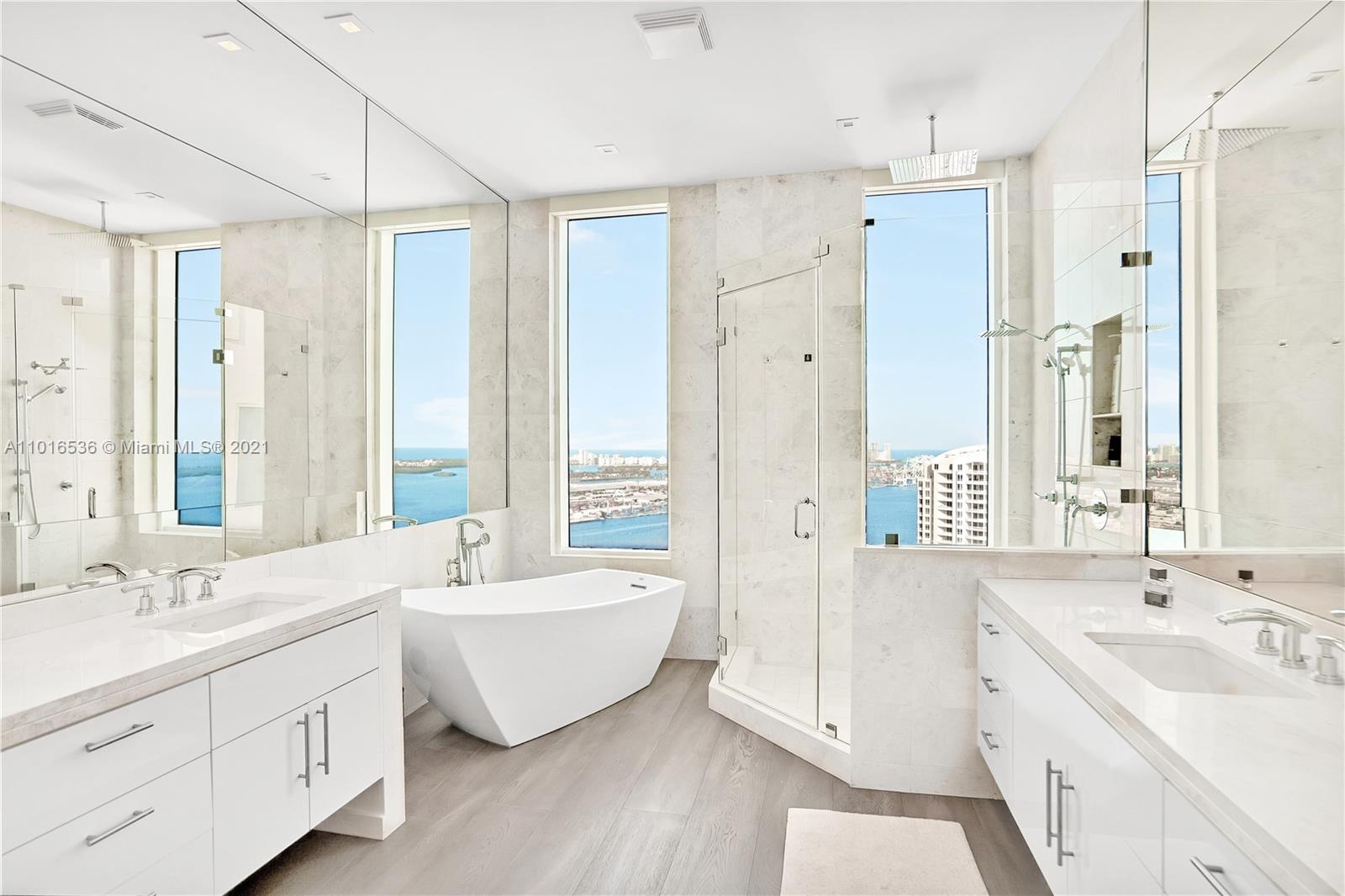 900 Brickell Key Boulevard, Unit PH4 Miami, FL 33131 - Photo 63 of 79 a spacious bathroom with a double vanity sink mirror and double