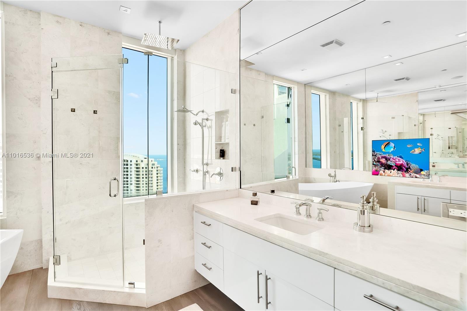900 Brickell Key Boulevard, Unit PH4 Miami, FL 33131 - Photo 64 of 79 a bathroom with a shower sink and mirror