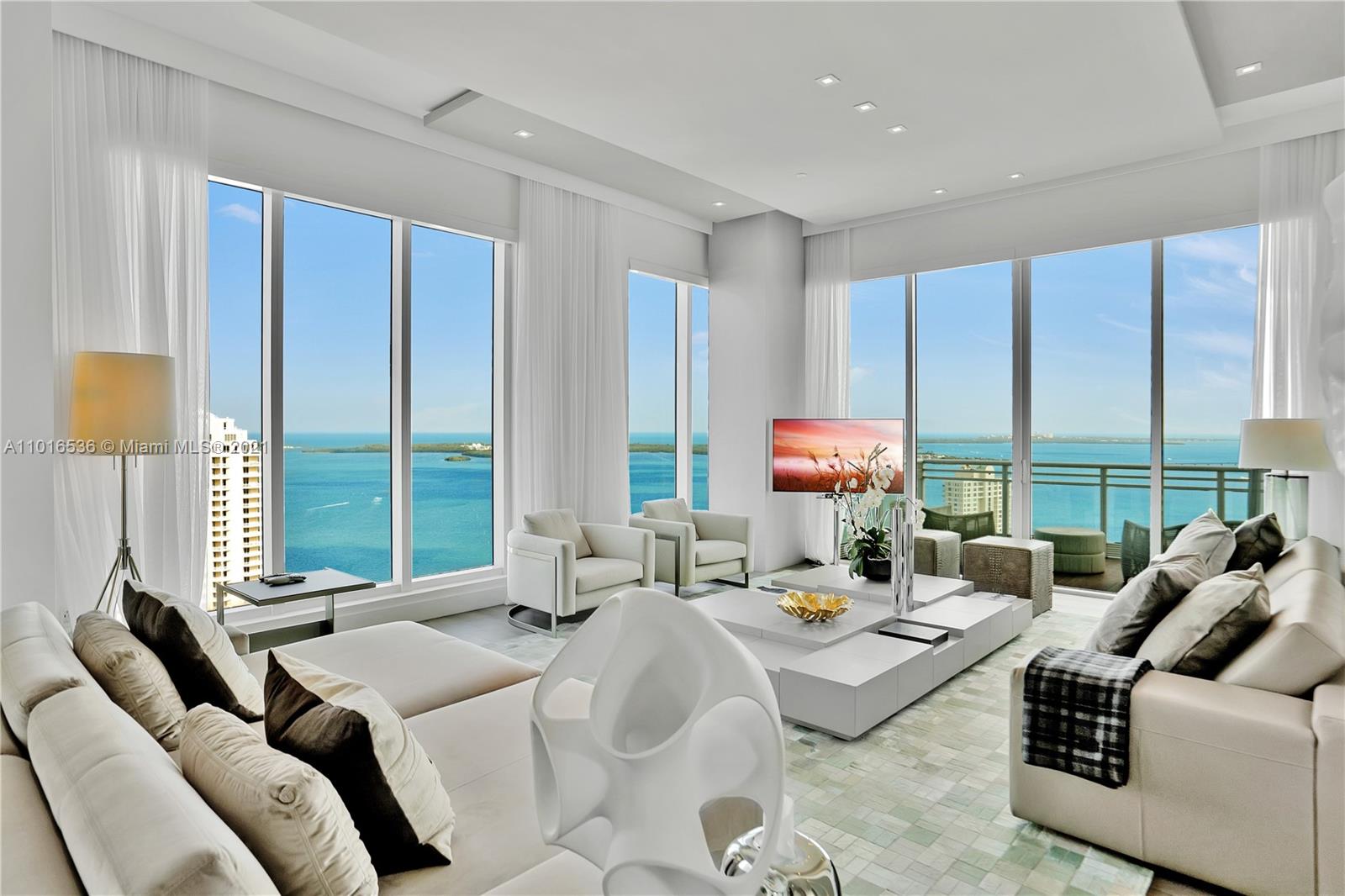 900 Brickell Key Boulevard, Unit PH4 Miami, FL 33131 - Photo 9 of 79 a living room with furniture and large windows