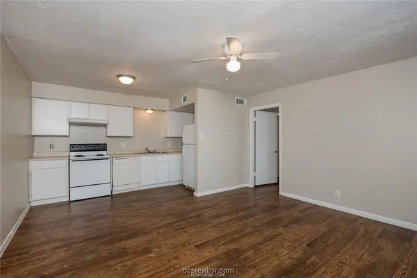 a view of kitchen with wooden floor and electronic appliances