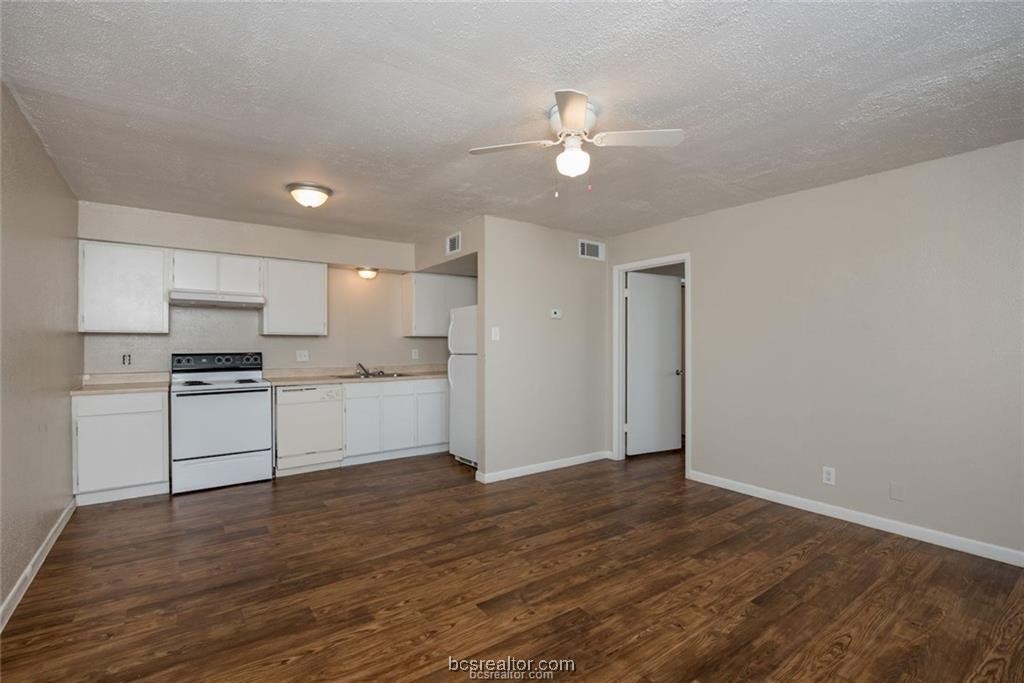 3900 Old College Road, Unit 32 Bryan, TX 77801 - Photo 3 of 10 a view of kitchen with wooden floor and electronic appliances