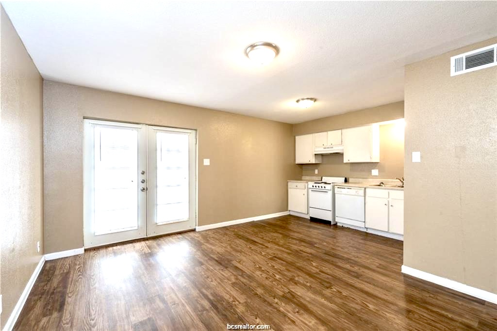 3900 Old College Road, Unit 32 Bryan, TX 77801 - Photo 7 of 11 a view of a kitchen with wooden floor