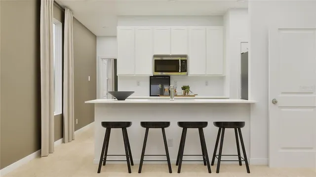 a dining room with furniture and a window