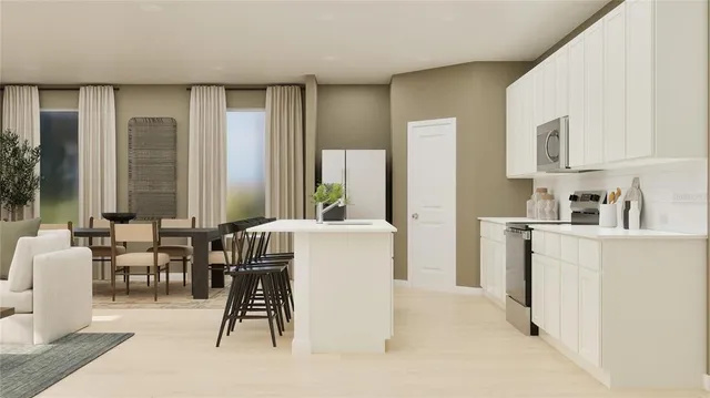 a living room with furniture a wooden floor and a large window