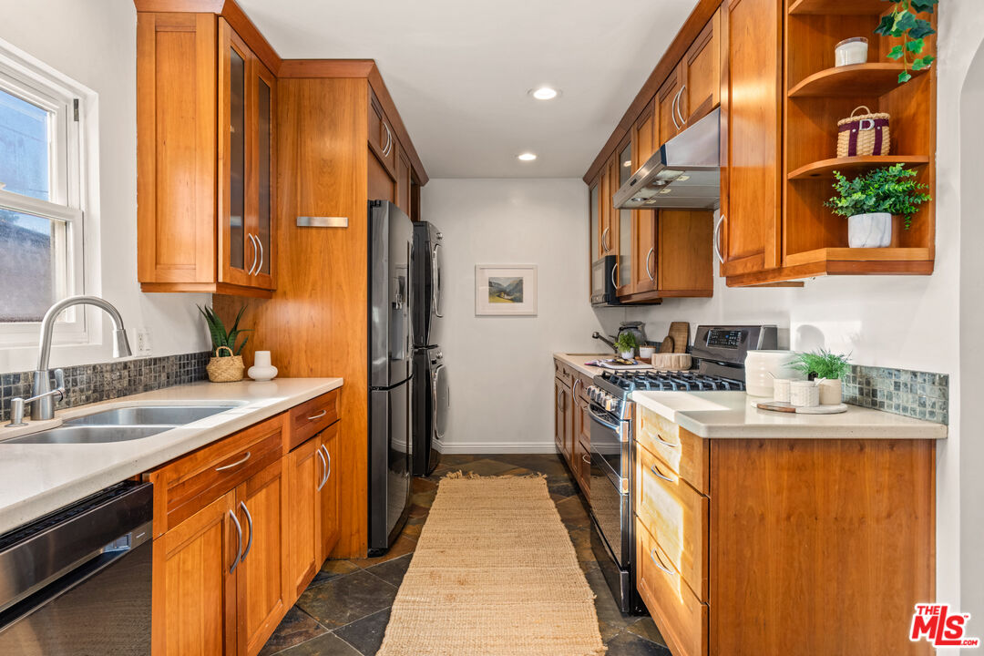 3344 Delaware Avenue Santa Monica, CA 90404 - Photo 12 of 28 a kitchen with stainless steel appliances granite countertop a stove a sink and a refrigerator