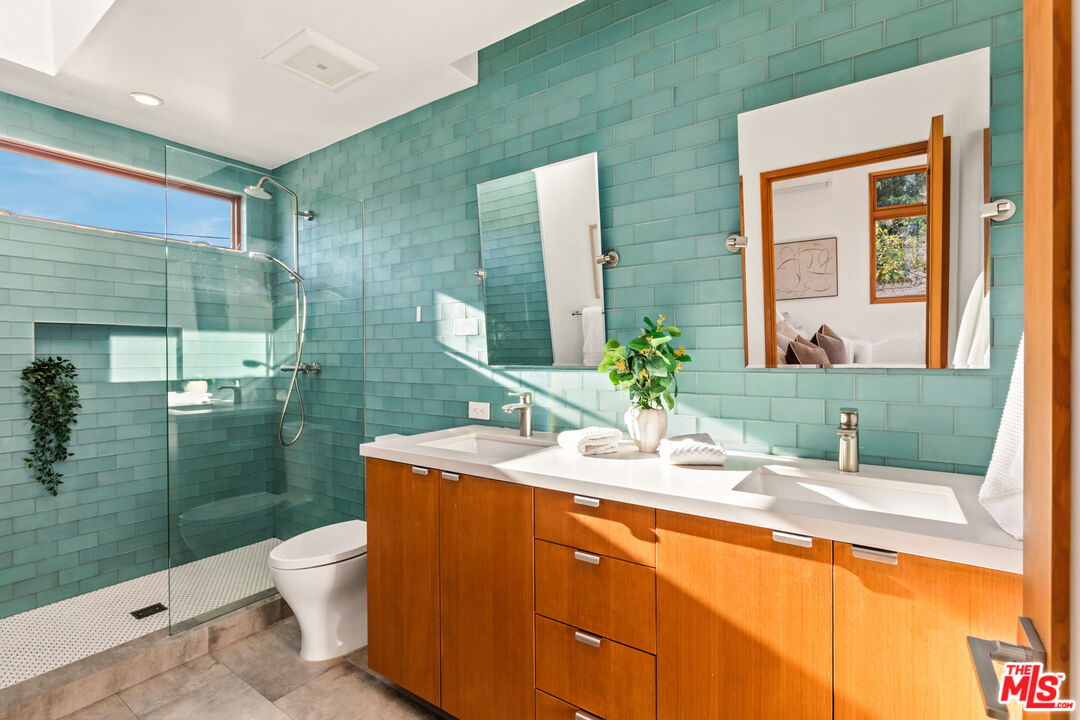 3344 Delaware Avenue Santa Monica, CA 90404 - Photo 15 of 28 a bathroom with a sink mirror toilet and shower