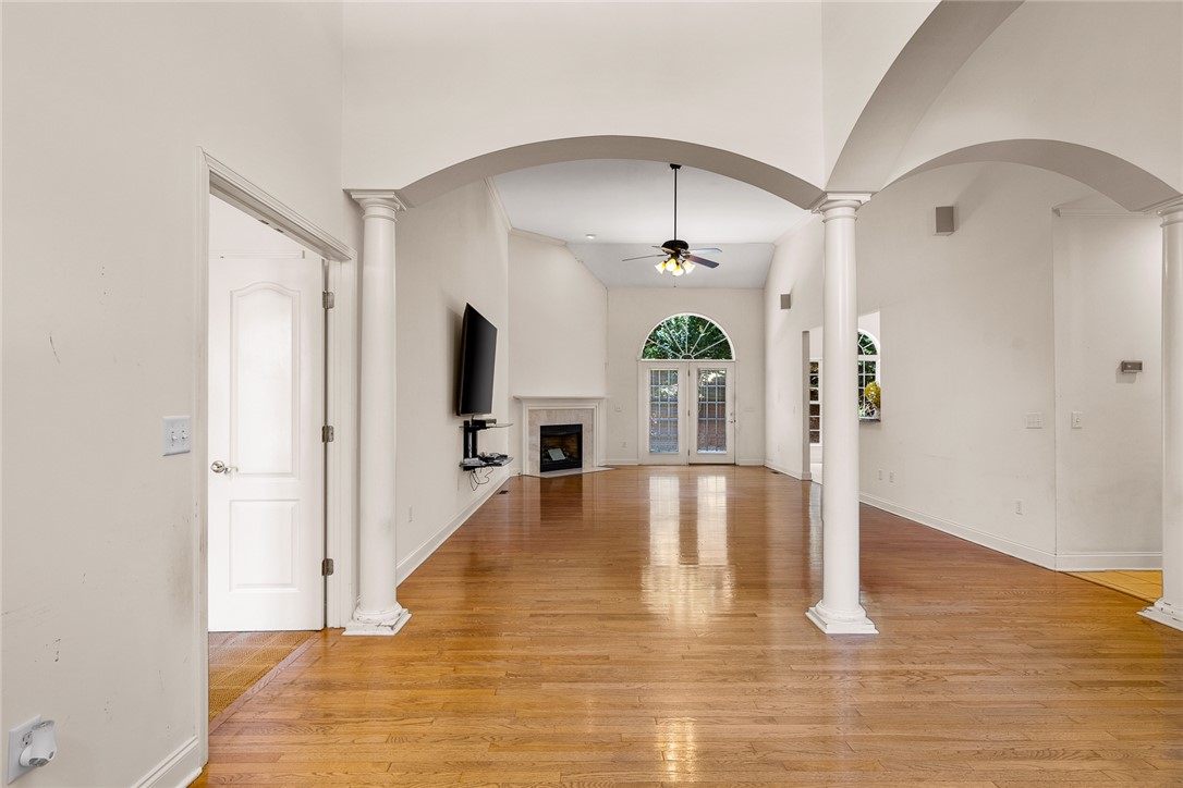 135 Sunset Bay Boulevard Seneca, SC 29672 - Photo 7 of 50 Vast living area with gleaming hardwood floors, an elegant fireplace, and vaulted ceilings, ready for your personalized touch.