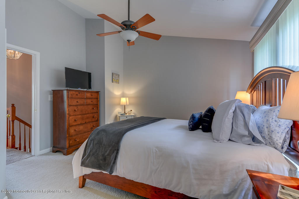55 Saxton Road Farmingdale, NJ 07727 - Photo 16 of 23 a bedroom with a bed and a flat tv screen on dresser
