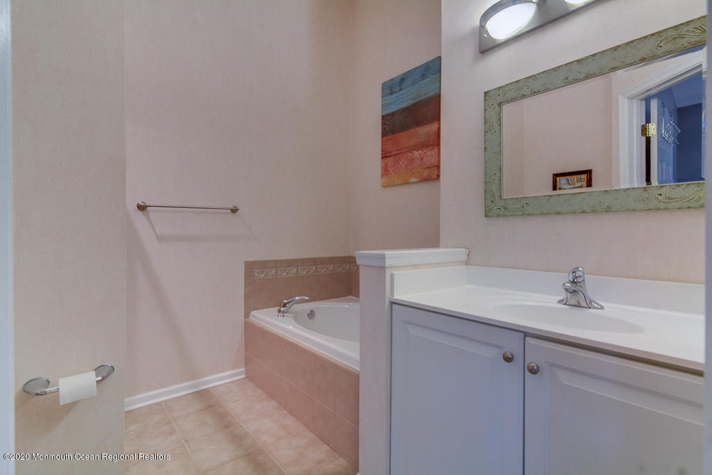 55 Saxton Road Farmingdale, NJ 07727 - Photo 17 of 23 a bathroom with a sink and a mirror
