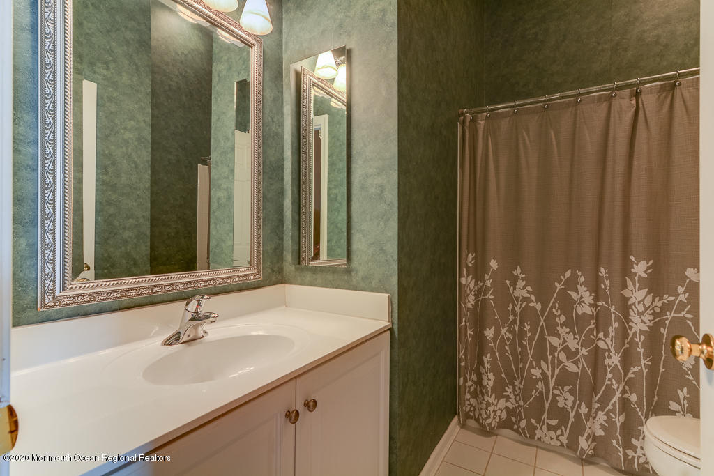 55 Saxton Road Farmingdale, NJ 07727 - Photo 21 of 23 a bathroom with a sink and a mirror