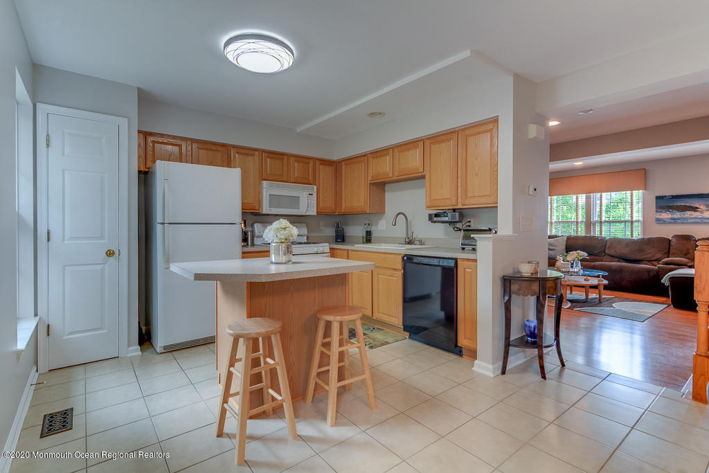 55 Saxton Road Farmingdale, NJ 07727 - Photo 6 of 23 a kitchen with stainless steel appliances granite countertop a stove a sink a refrigerator and a refrigerator
