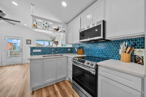a kitchen with stainless steel appliances a stove a sink and a microwave