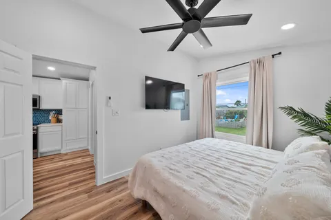 a bedroom with a bed and a flat screen tv